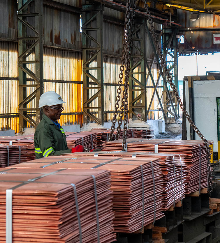 IRH worker overseeing copper cathode stacks at Mopani Copper Mines facility